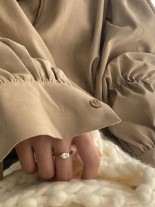 Close-up of elegant gold 925 sterling silver ring featuring a clear oval gemstone on finger