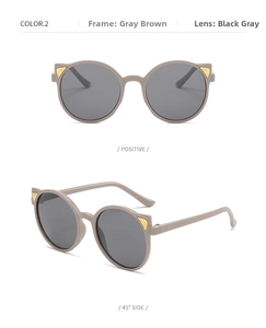 Detail views of grey-brown cat-ear sunglasses with dark lenses and gold triangle decor