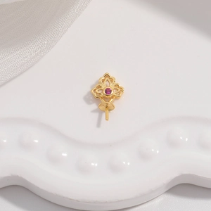 Macro detail of gold-plated S925 silver pendant setting with pink stone and pearl pin