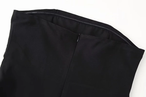 Detail of hidden zipper and silicone anti-slip strip on black tube dress neckline