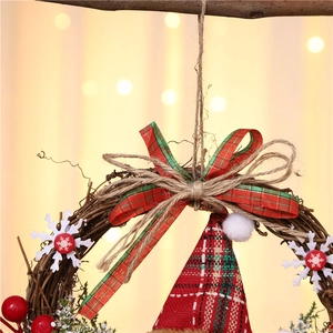 Close-up of a rustic Christmas wreath with Santa elements and red berry accents