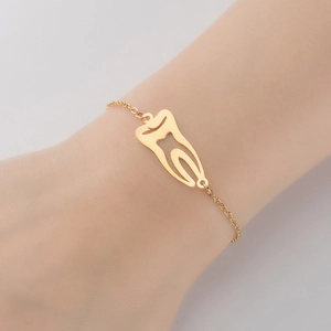 Gold stainless steel tooth pendant bracelet featuring a minimalist hollow molar design
