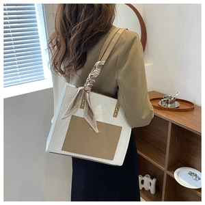 Detail of contrast stitch tote bag with silk scarf handle and FASHION BAG logo
