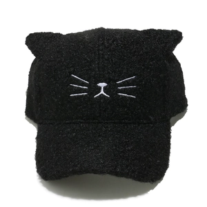 Detail of black faux lamb wool cat ear baseball cap with white whiskers embroidery