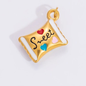 Macro view of a gold-plated heart enamel pendant featuring 'Sweet' engraving detail
