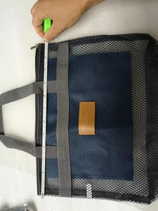 Vista dettagliata della borsa a rete blu scuro con un'altezza di circa 30 cm in misura