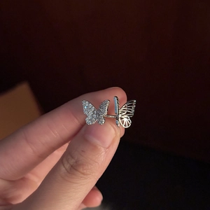 Silver butterfly ear cuff with sparkling white zircon stones and hollow wire design