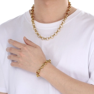Detail showing elegant gold chain necklace and matching bracelet on model with pearls