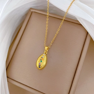 Elegant gold titanium necklace with oval multi-color crystal pendant on white fabric