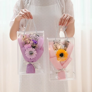 Detail of soap flower bouquets with LED string lights in clear portable gift bags
