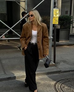 Detailed view of women brown suede blazer featuring notch lapels and single-breasted buttons