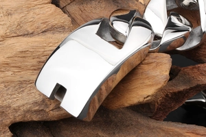 Macro detail of polished silver stainless steel Cuban chain link with mirror finish