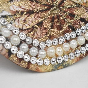 Baseball cap with colorful prints, sparkling rhinestones, and white pearl decorations