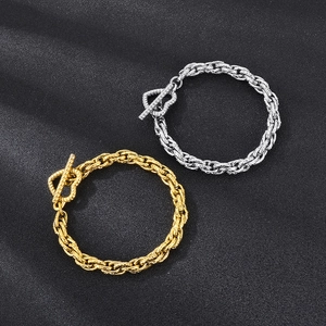 Detailed macro view of gold and silver chunky link bracelets with classic T-bar clasps