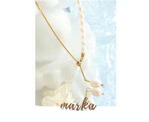 Detail of freshwater pearl necklace with gold snake chain and adjustable drop pendant