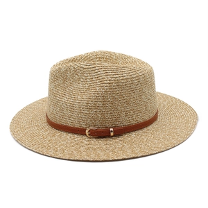 Detail of Panama hat woven texture with brown leather band and golden buckle