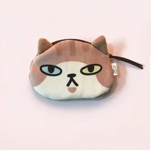 Creative plush cat coin purse with odd-eyed design and zipper on purple background