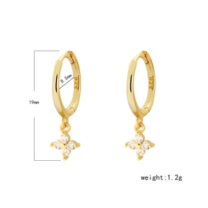 Close-up of 925 sterling silver four-leaf clover earrings with white zircons in gold finish
