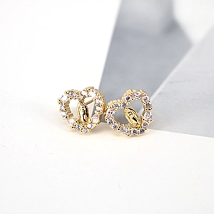 Vintage heart-shaped gold earrings featuring pavé cubic zirconia and religious motifs