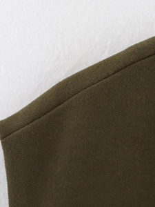 Close-up of olive green casual vest showing suede texture and neat stitching details