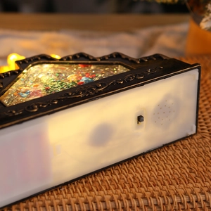 Detail view of the vintage Christmas lantern base with speaker and functional switch