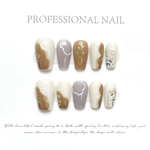 Detailed view of handmade press-on nails with gold foil, line art and ink splatter texture