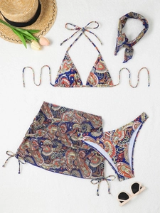 Flat lay of 4-piece paisley print navy bikini set with matching sarong and headband