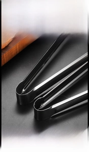 Detail of thickened stainless steel food tongs with brushed finish for ice or BBQ