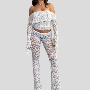 Sexy white lace two-piece set featuring off-shoulder ruffle top and flared sheer pants