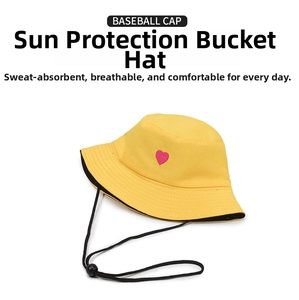 Detail of yellow cotton bucket hat with pink heart embroidery and black windproof chin strap