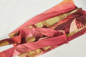 Macro detail of reddish-brown abstract print fabric with fine textured weave texture
