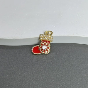Detail view of a red enamel Christmas stocking pendant with pearls and snowflake zircon