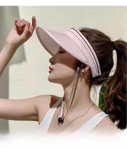 Detail of pink visor brim with SUNSHINE lettering and adjustable side strap