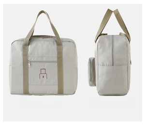Detail view of foldable Oxford fabric travel bag with luggage sleeve for suitcase handle