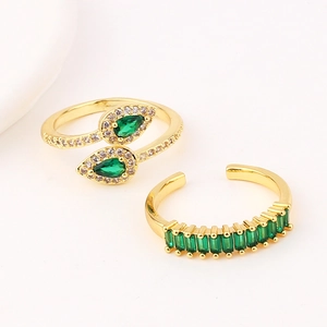 Close-up of gold-plated emerald zircon rings showing precise gemstone cutting and polishing