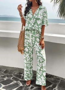 Detail of green and white botanical print on a lightweight summer shirt and pants set