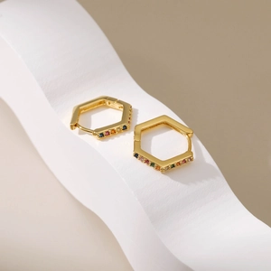 18K gold hexagonal hoop earrings with colorful rainbow cubic zirconia on white waves