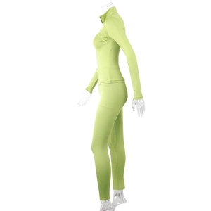 Detail of teal green two-piece yoga set with zip-up stand collar and slim fit trousers