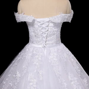 Off-shoulder lace wedding dress with corset back design and delicate pearl embroidery