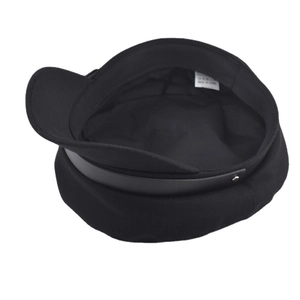 Detail view of cotton military cap with leather strap decoration and inner care label