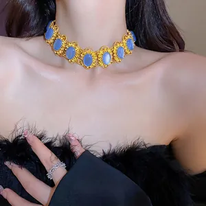 Elegant vintage gold choker necklace with oval blue gemstones and intricate filigree design