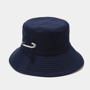 Detail of navy blue cotton bucket hat with rhinestone pin and parallel stitching