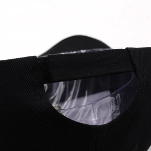 Rear view of black cotton baseball cap showing adjustable velcro strap and twill texture