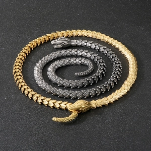 Detailed view of snake-shaped necklace with realistic scale texture in gold and silver