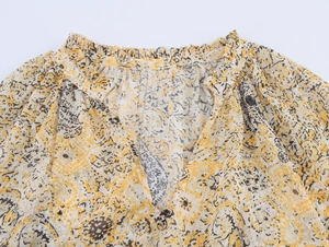 Detail of V-neckline and ruching on a floral print chiffon shirt for women