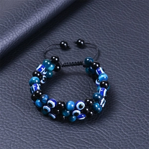 Macro detail of 8mm evil eye bracelet with tiger eye beads and triple woven cord