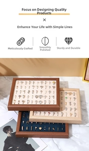 Detail of walnut wood jewelry display trays with velvet lining for rings and studs