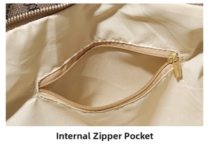 Macro view of a large tote bag interior featuring a golden zipper and beige fabric lining