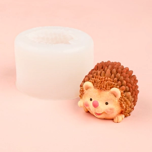 3D hedgehog silicone mold and finished mousse cake model on a soft pink background