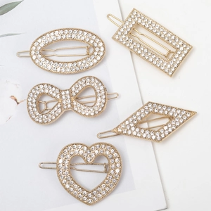 Five gold alloy hair clips with rhinestones in heart, bow and geometric shapes